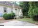 Rear side view of the property showcasing the landscaping, utility access, and architectural features at 433 Abbey Springs Way, Mcdonough, GA 30253