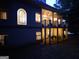 Back of home features arched window, covered upper and lower patios, and lush greenery at 433 Abbey Springs Way, Mcdonough, GA 30253