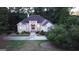 Beautiful home displaying a well-kept lawn and welcoming front entrance framed by mature trees at 433 Abbey Springs Way, Mcdonough, GA 30253