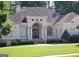 Elegant home featuring a well-manicured lawn and a stately entrance with a detailed archway and decorative wreaths at 433 Abbey Springs Way, Mcdonough, GA 30253