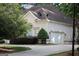 House exterior displaying a spacious driveway and a two-car garage at 433 Abbey Springs Way, Mcdonough, GA 30253