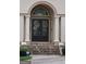 Elegant front entrance featuring double doors, decorative wreaths, and inviting stone steps at 433 Abbey Springs Way, Mcdonough, GA 30253
