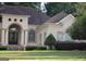 Stately home featuring a beautiful arched entrance, manicured landscaping, and an ADT security sign at 433 Abbey Springs Way, Mcdonough, GA 30253