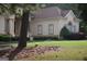 Charming home showcasing arched windows, a manicured lawn, and mature trees for added curb appeal at 433 Abbey Springs Way, Mcdonough, GA 30253