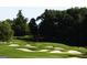 A lovely golf course featuring sand traps and lush green fairways surrounded by mature trees at 433 Abbey Springs Way, Mcdonough, GA 30253