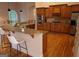 Open kitchen design with granite countertops, stainless appliances, and hardwood floors at 433 Abbey Springs Way, Mcdonough, GA 30253