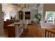 Open concept living space with kitchen bar, hardwood floors, and large windows at 433 Abbey Springs Way, Mcdonough, GA 30253