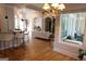 Open-concept living room with hardwood floors, bar seating, and natural light at 433 Abbey Springs Way, Mcdonough, GA 30253