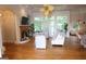 Cozy living room with large windows, hardwood floors, and a decorative ceiling fan at 433 Abbey Springs Way, Mcdonough, GA 30253