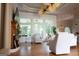 Cozy living room with large windows, hardwood floors, and a decorative ceiling fan at 433 Abbey Springs Way, Mcdonough, GA 30253