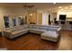 Large living room with hardwood floors, access to outdoor living space, and open to the kitchen at 433 Abbey Springs Way, Mcdonough, GA 30253