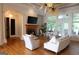 Bright living room featuring hardwood floors, a fireplace, and plenty of natural light at 433 Abbey Springs Way, Mcdonough, GA 30253