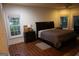 This spacious main bedroom features hardwood floors, natural lighting, and matching nightstands at 433 Abbey Springs Way, Mcdonough, GA 30253