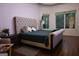 Comfortable bedroom with large windows, plush bedding, and hardwood floors at 433 Abbey Springs Way, Mcdonough, GA 30253