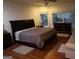 This cozy main bedroom is equipped with a ceiling fan, a large bed, and a view of the outdoors at 433 Abbey Springs Way, Mcdonough, GA 30253