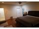 The main bedroom features a dark wood bed frame, neutral colored walls, and hardwood flooring at 433 Abbey Springs Way, Mcdonough, GA 30253