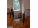 A staircase featuring wood steps and black metal railings and a decorative window at 433 Abbey Springs Way, Mcdonough, GA 30253