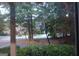 View through a window of a basketball hoop and a red brick house with dormers at 433 Abbey Springs Way, Mcdonough, GA 30253