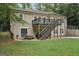 Back of house with a large lawn and a deck that features a staircase at 140 Alford Dr, Fayetteville, GA 30215