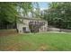 Back of house with a deck and patio on a large lawn at 140 Alford Dr, Fayetteville, GA 30215