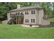 House on a vast green lawn featuring a deck, staircase, and patio; perfect for outdoor enjoyment at 140 Alford Dr, Fayetteville, GA 30215