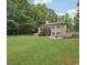 Expansive backyard with mature trees, and a raised deck overlooking the lawn, offering a private and serene outdoor space at 140 Alford Dr, Fayetteville, GA 30215