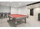 Finished basement with pool table, black ceiling beams, recessed lighting, and three barstools at 140 Alford Dr, Fayetteville, GA 30215