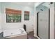 A bright, spa-like bathroom with soaking tub and glass enclosed shower at 140 Alford Dr, Fayetteville, GA 30215