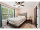 Bedroom features a dark wood bed frame, closet, and a window with backyard views at 140 Alford Dr, Fayetteville, GA 30215