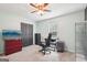 Bedroom featuring a dark accent wall, a desk, a TV, and neutral carpet at 140 Alford Dr, Fayetteville, GA 30215