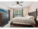 Cozy bedroom features a dark wood bed frame, closet, and window with backyard views at 140 Alford Dr, Fayetteville, GA 30215
