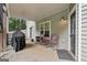 Cozy covered patio featuring outdoor seating, a grill, and access to the lush backyard for outdoor enjoyment at 140 Alford Dr, Fayetteville, GA 30215