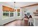 Well-lit dining area with hardwood floors, a chandelier and beautiful window views at 140 Alford Dr, Fayetteville, GA 30215