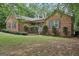 Charming brick home featuring a well-manicured lawn and classic architectural details at 140 Alford Dr, Fayetteville, GA 30215