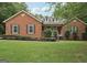 Charming brick home featuring a well-manicured lawn and classic architectural details at 140 Alford Dr, Fayetteville, GA 30215