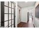 Hallway access to eat-in kitchen featuring storage cabinets and hardwood floors at 140 Alford Dr, Fayetteville, GA 30215