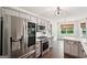 Eat-in kitchen features stainless steel appliances, a view to the backyard, and hardwood floors at 140 Alford Dr, Fayetteville, GA 30215
