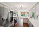 Modern eat-in kitchen with stainless steel appliances, grey cabinets and hardwood floors at 140 Alford Dr, Fayetteville, GA 30215