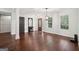 Bright, open-plan living room boasts hardwood floors and a modern light fixture at 140 Alford Dr, Fayetteville, GA 30215