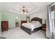 The main bedroom boasts a tray ceiling, neutral carpet, and lots of natural light at 140 Alford Dr, Fayetteville, GA 30215