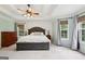 Large main bedroom with a trey ceiling, dark-stained furniture, and natural light from multiple windows at 140 Alford Dr, Fayetteville, GA 30215