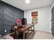 Home office features desk, backyard view and stylish accent wall at 140 Alford Dr, Fayetteville, GA 30215