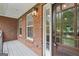 Enclosed porch featuring brick wall, plank ceiling, and a decorative hanging light fixture at 140 Alford Dr, Fayetteville, GA 30215