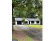 Charming ranch-style home featuring a black two-car garage and a well-manicured lawn at 168 Park Ln, Dallas, GA 30157