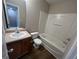 Bathroom featuring a vanity, toilet, and bathtub with shower head at 160 Odyssey Turn, Conyers, GA 30012