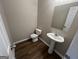 Half bathroom featuring a pedestal sink and toilet with vinyl flooring at 160 Odyssey Turn, Conyers, GA 30012