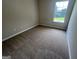 Bedroom featuring neutral carpet, neutral paint, and a bright window at 160 Odyssey Turn, Conyers, GA 30012