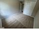 Bedroom featuring neutral carpet, neutral paint, and double door closet at 160 Odyssey Turn, Conyers, GA 30012