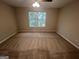 A cozy bedroom with plush carpeting, neutral paint, a ceiling fan, and a window at 160 Odyssey Turn, Conyers, GA 30012
