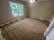 Bedroom featuring neutral carpet, neutral paint, and a bright window at 160 Odyssey Turn, Conyers, GA 30012